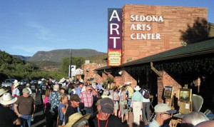 People waiting outside of an arts center.