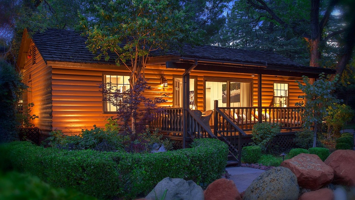 A cottage in the evening, lit by warm light