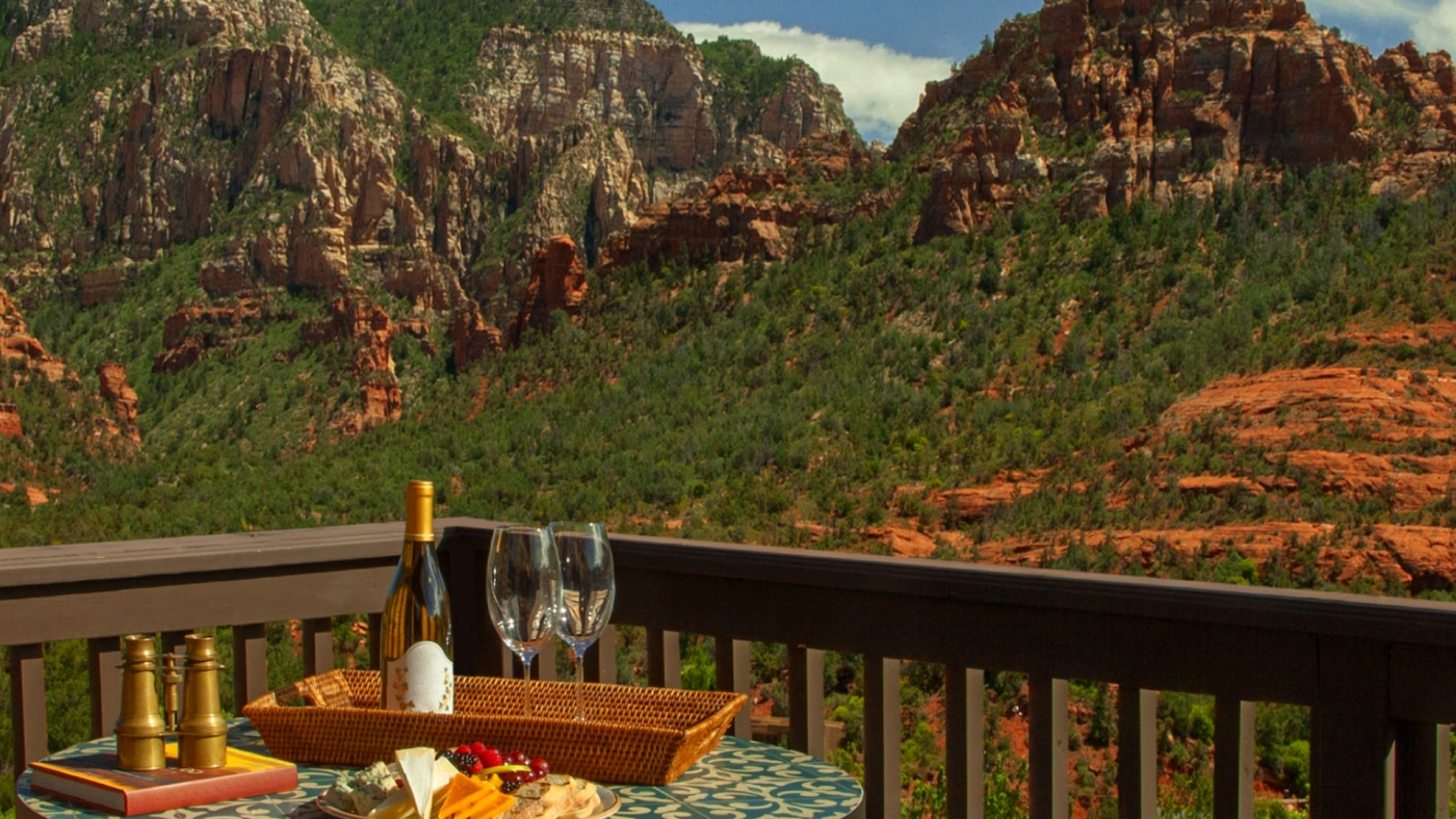 A table with wine and snacks overlooking a mountain side
