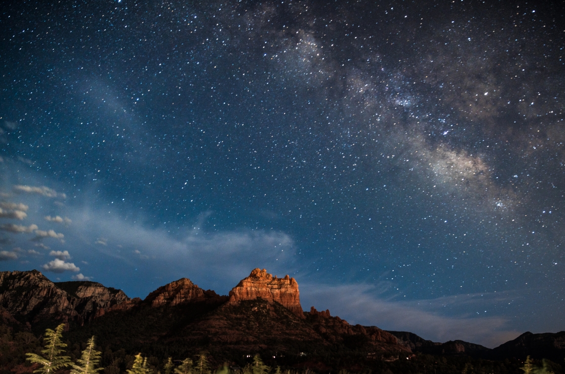 night sky filled with stars and the milky way over the Sedona red rocks
