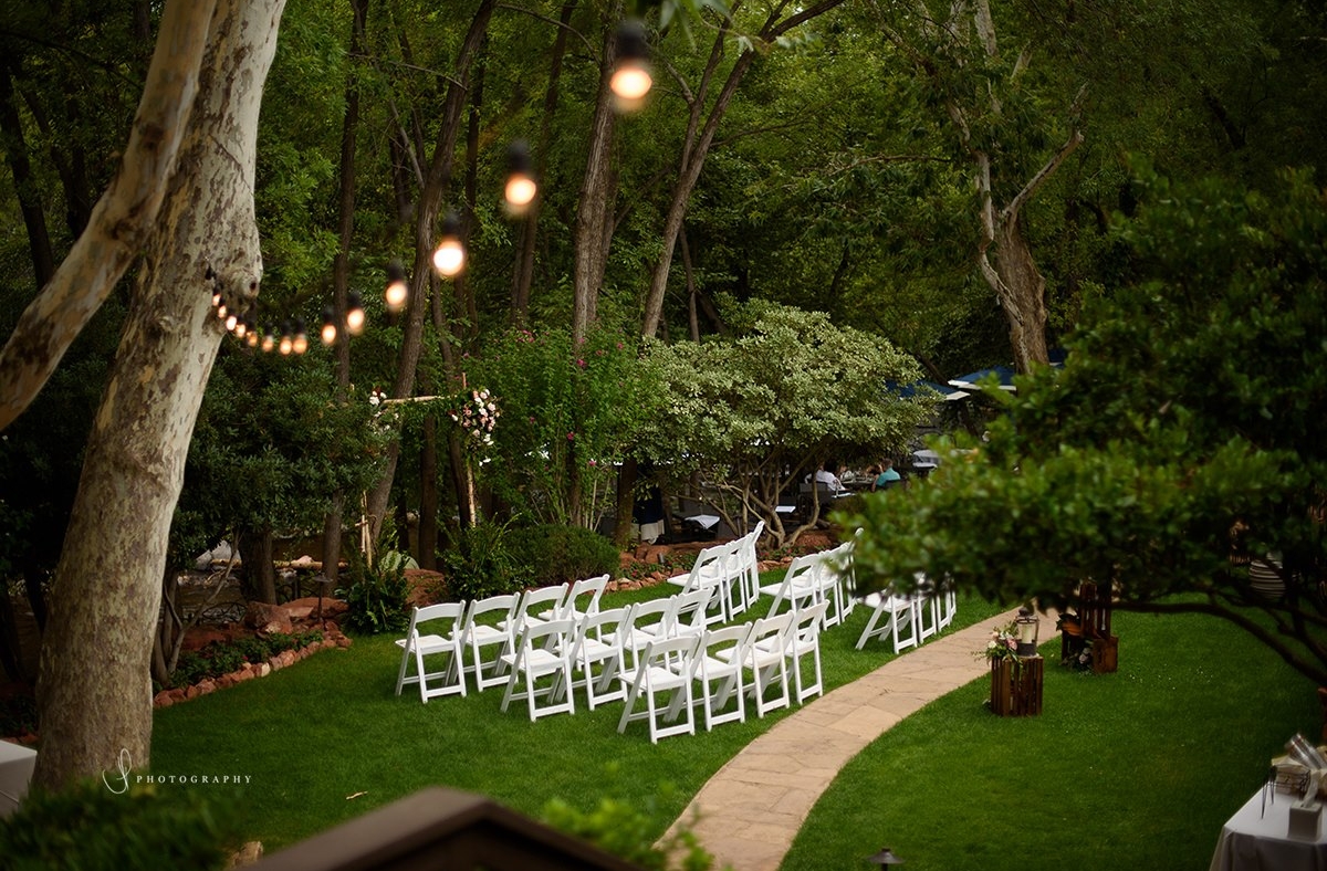 chairs set outside for wedding ceremony surrounded by trees