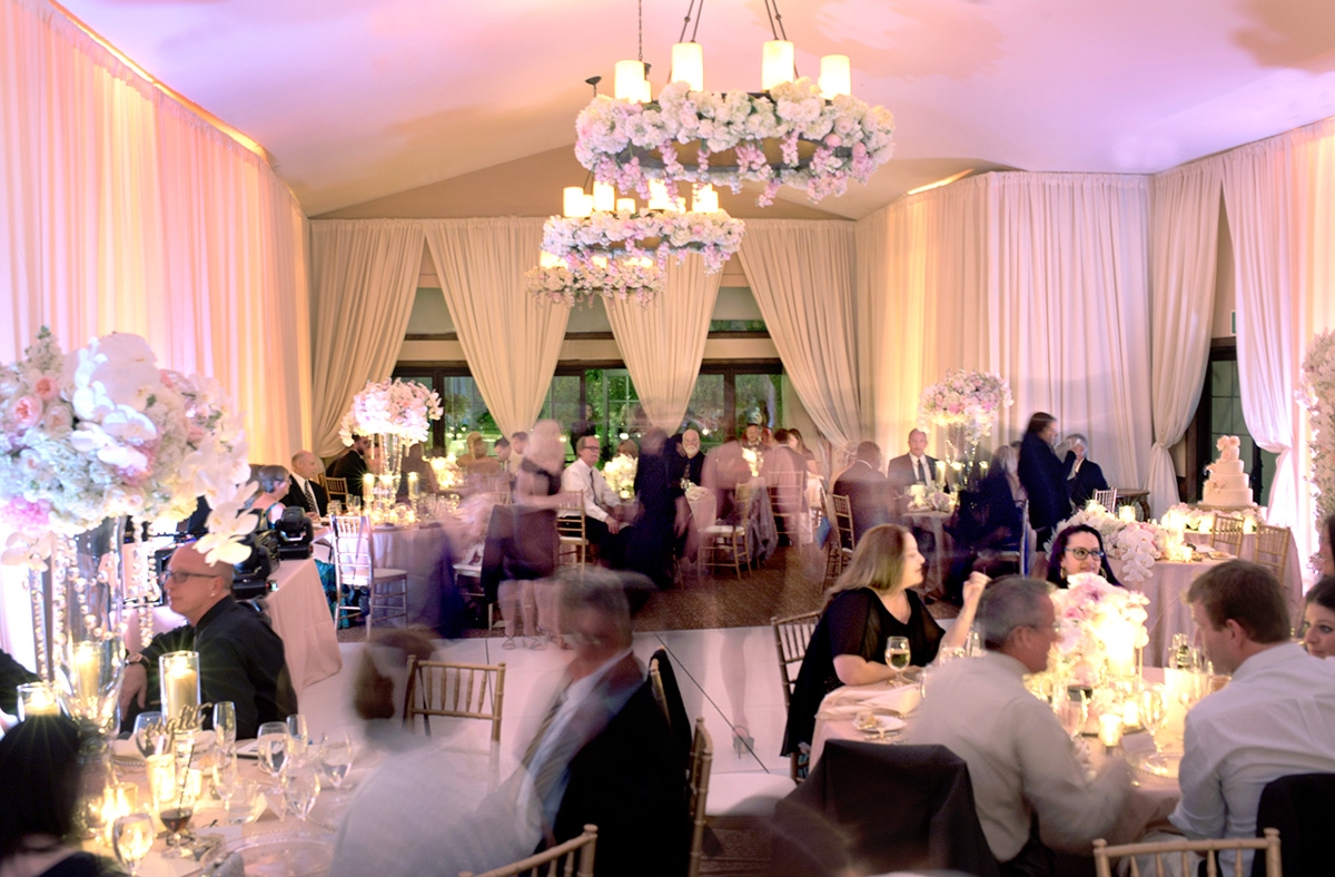 Inside the Monet ballroom, filled with guests and decorations for a wedding.
