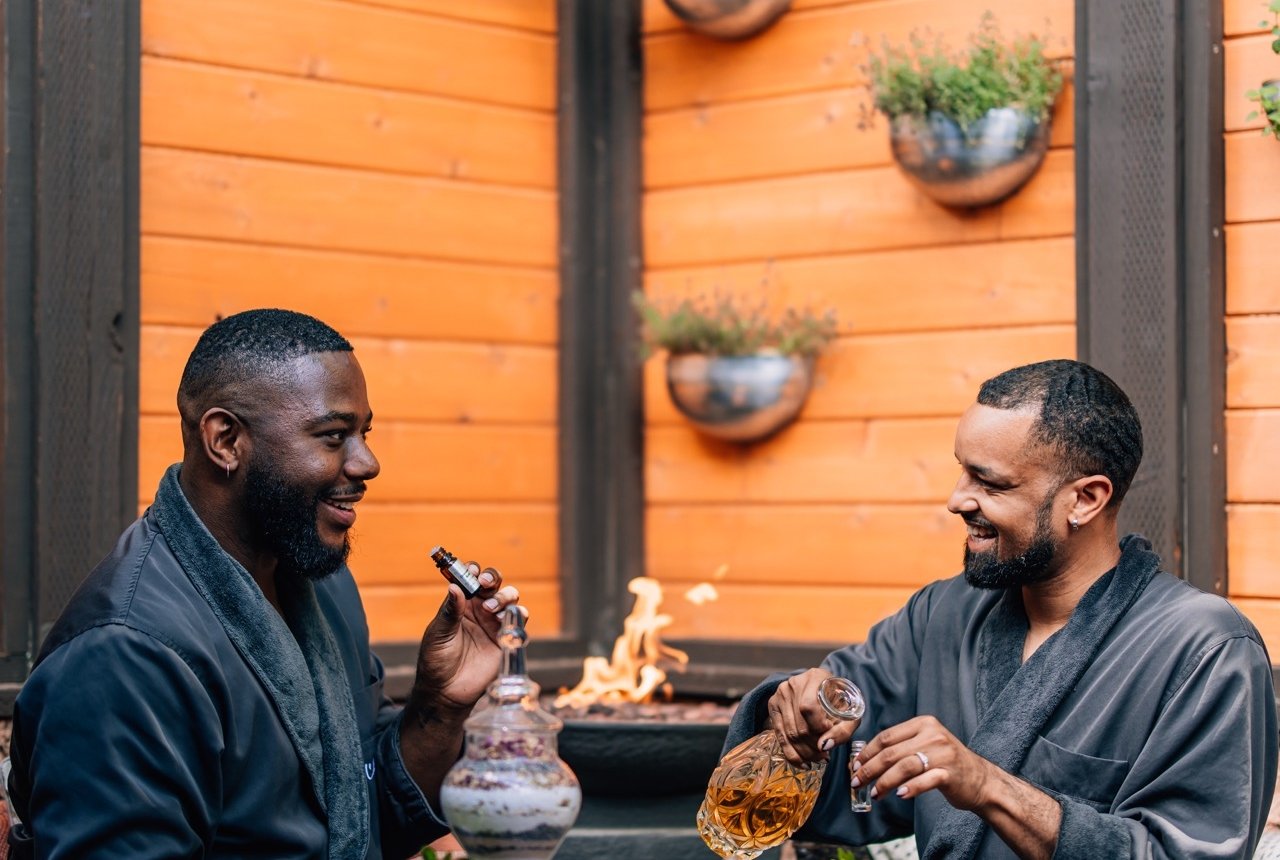 two people enjoying wine and smelling aromatherapy scent at L'Apothecary spa