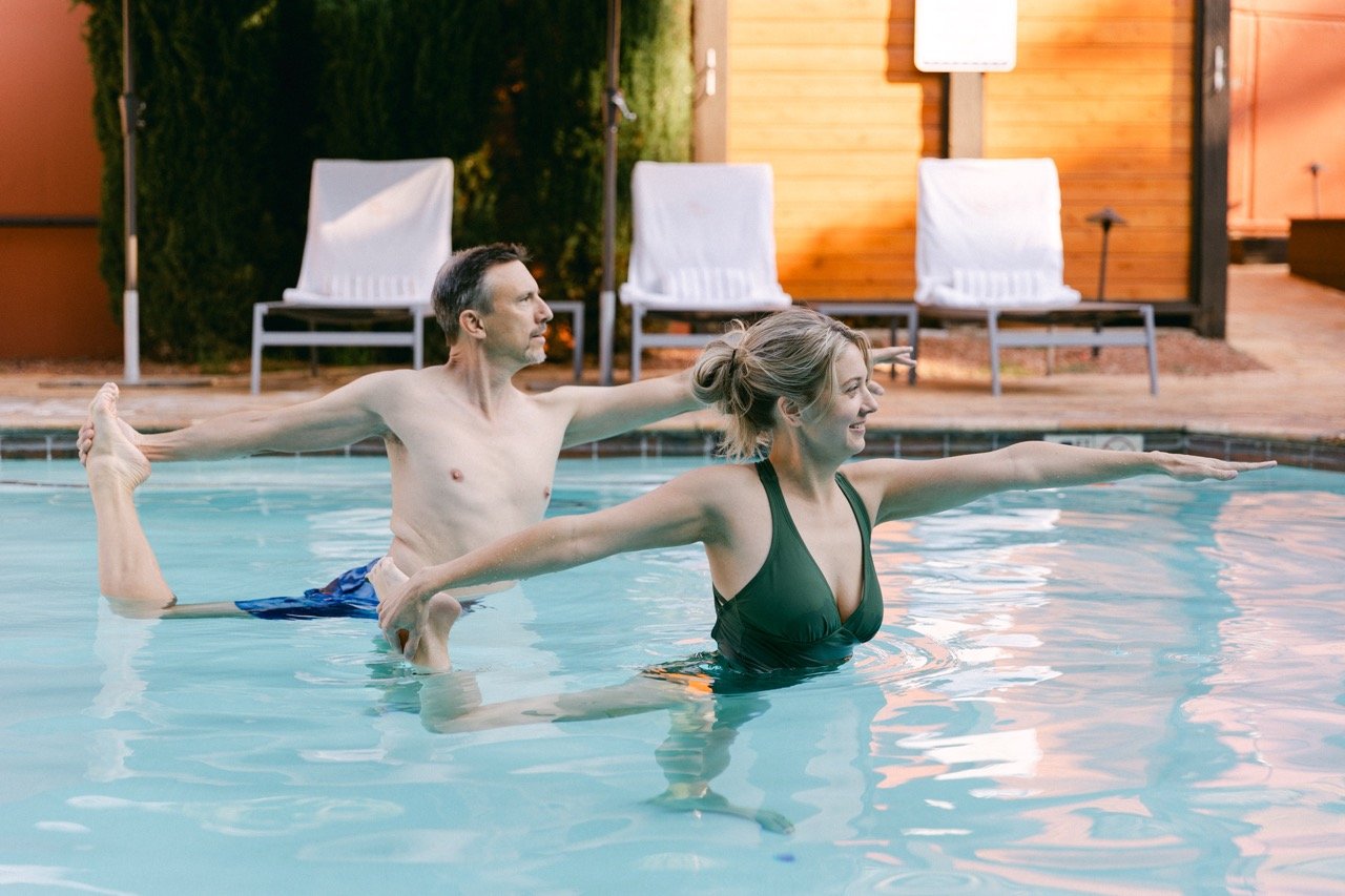 Two people preforming water aerobics at L'Apothecary spa
