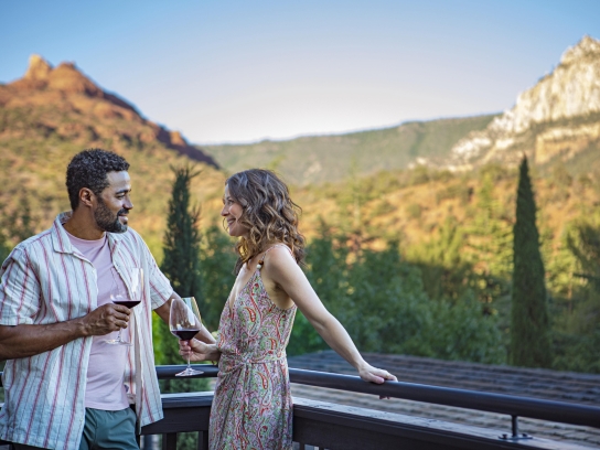 Couple with red wine on the balcony