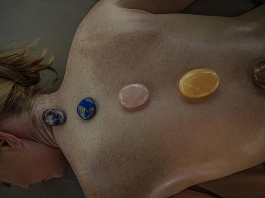 Person receiving stone treatment at L'Apothecary spa