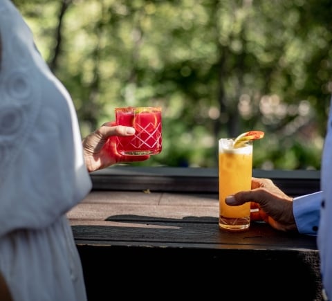 people holding different cocktails at the Cress Bar