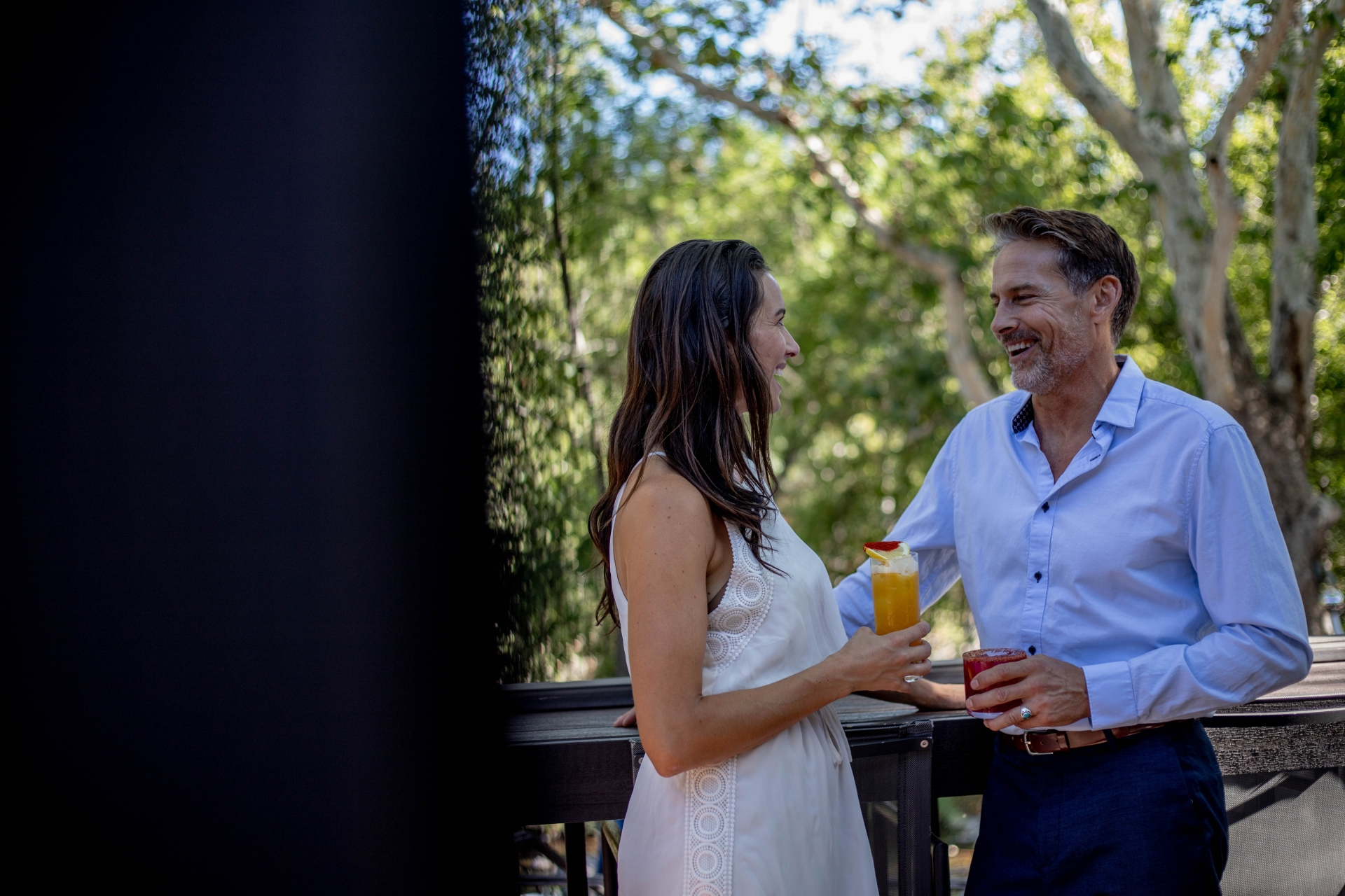 Two people conversing with cocktails at the Cress Bar