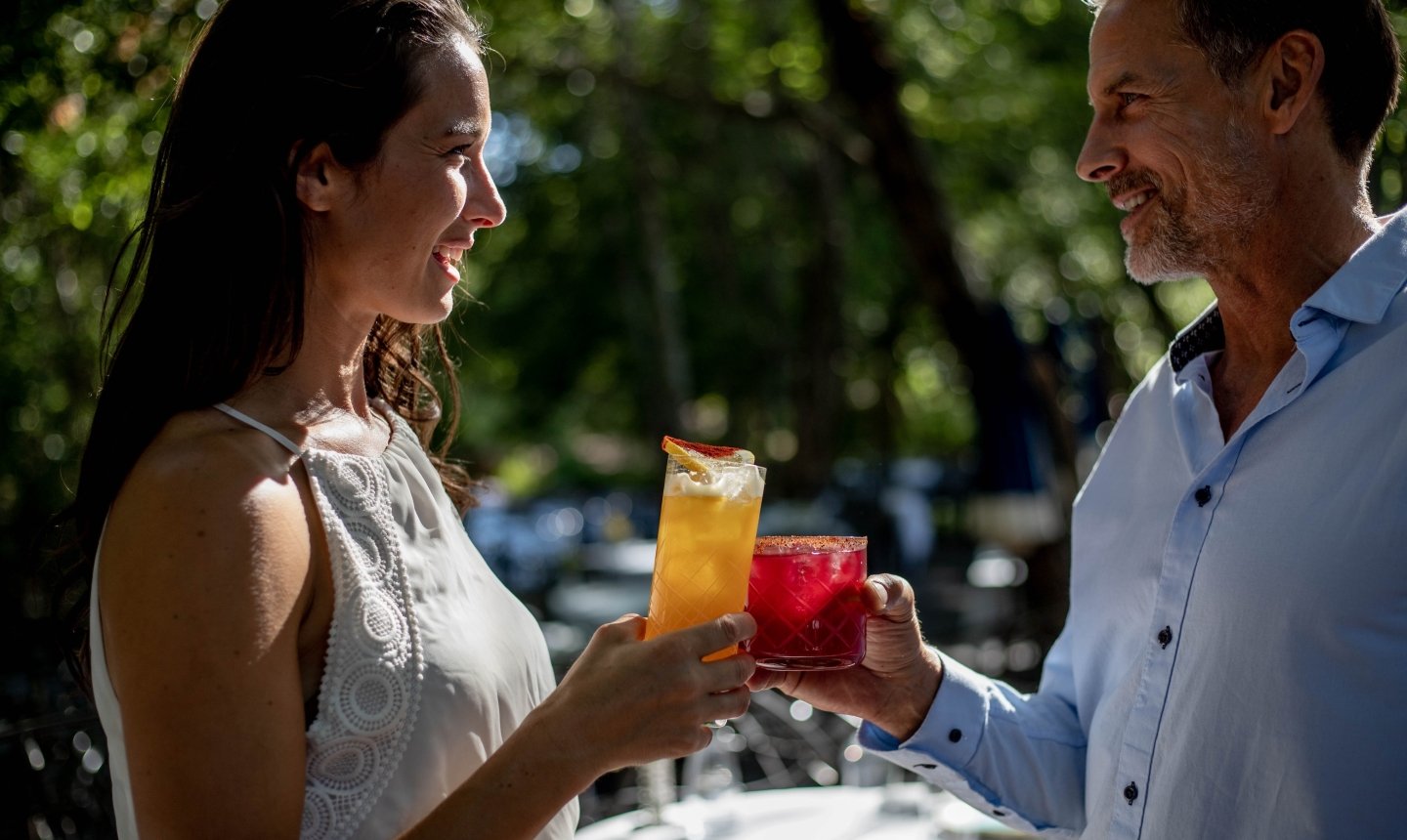 Two people conversing with cocktails at the Cress Bar