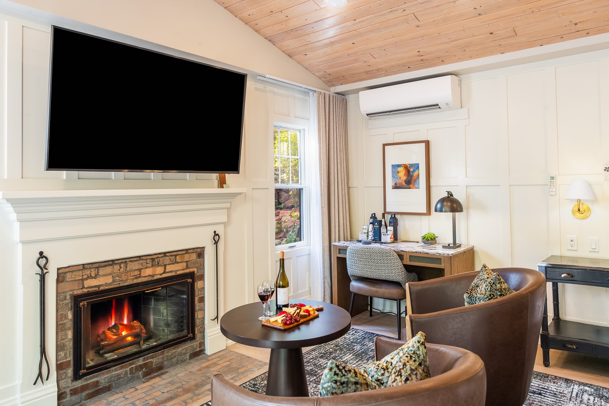 A cozy living area with a fireplace, TV, and seating for relaxation.