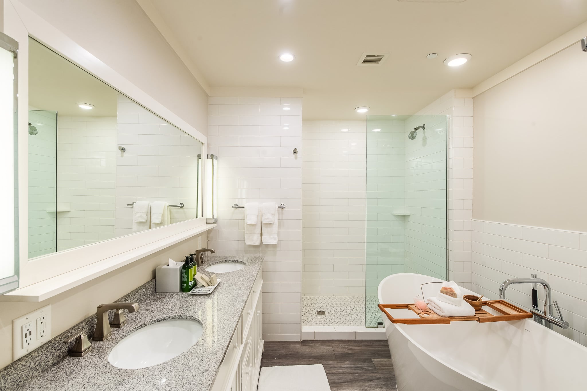A clean and modern bathroom with a double vanity, separate shower, and soaking tub.