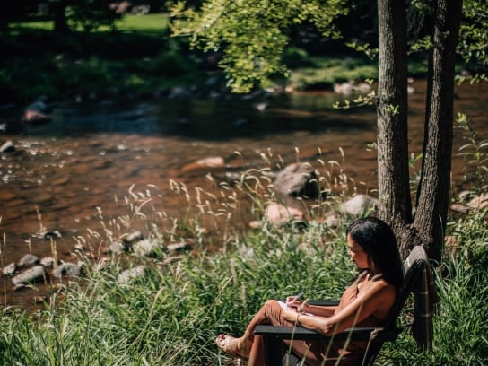 Woman Sitting Creekside