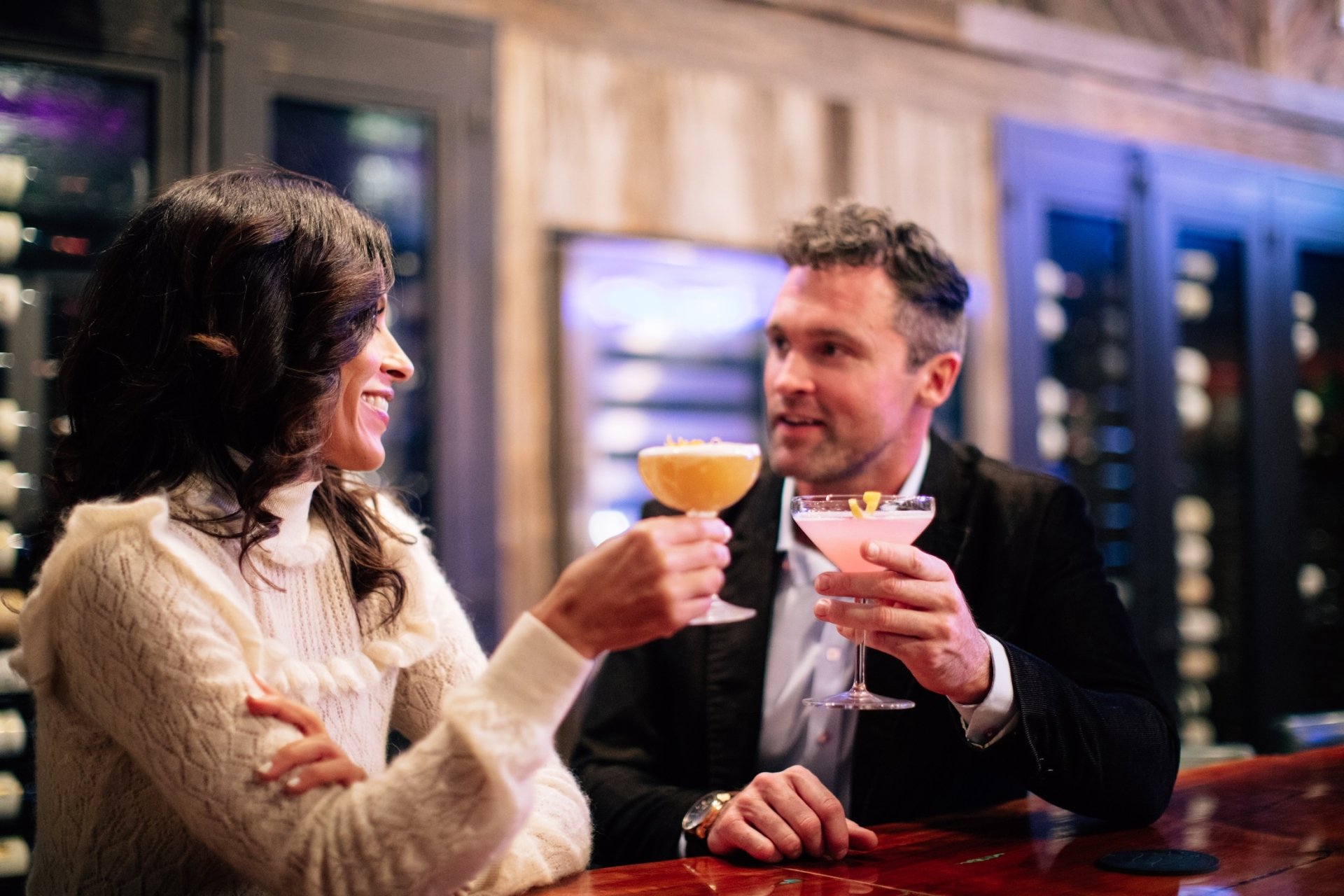 Couple at The Bar with Cocktails