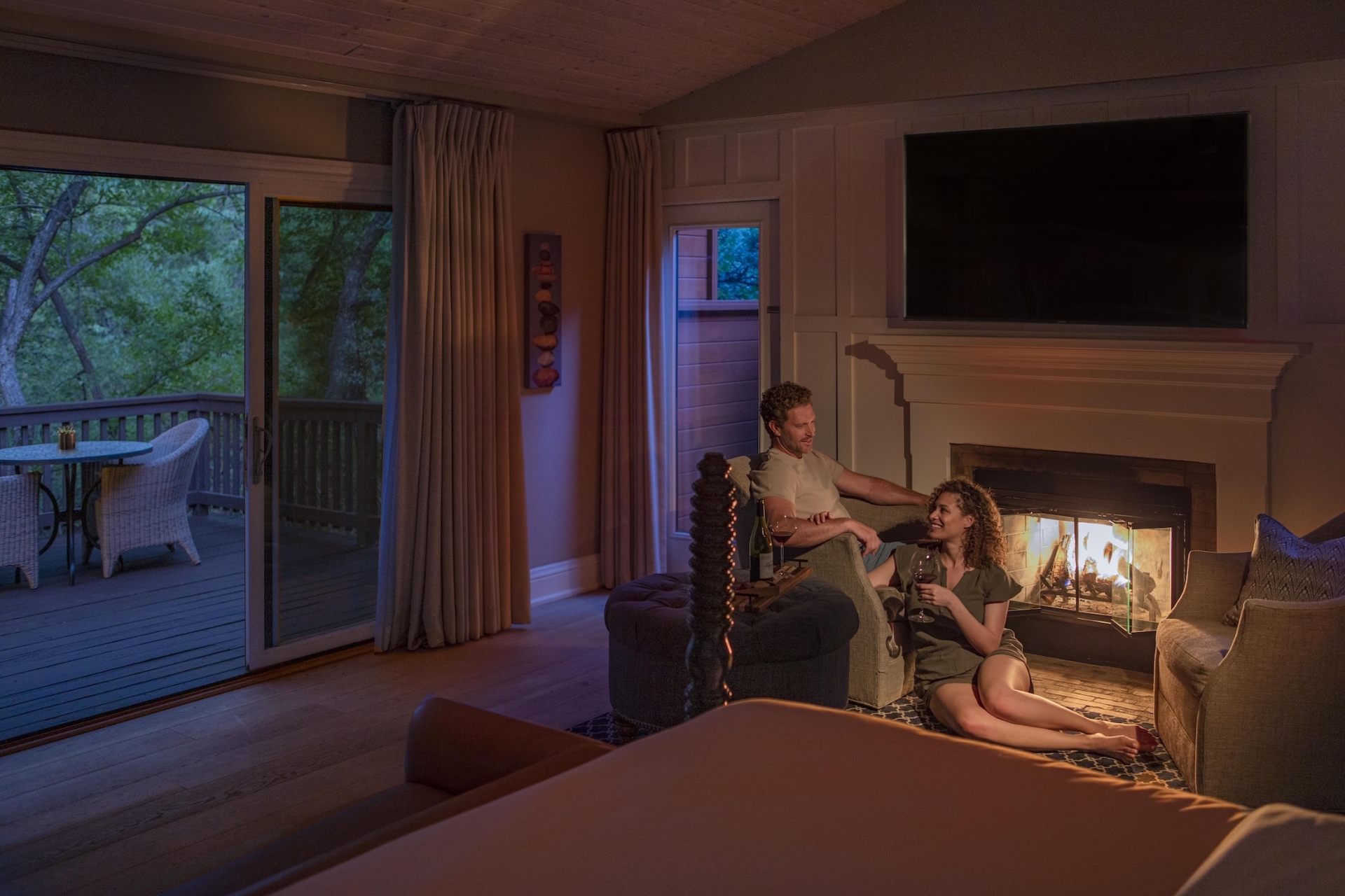 Creekside Cottage with Couple in front of Fireplace