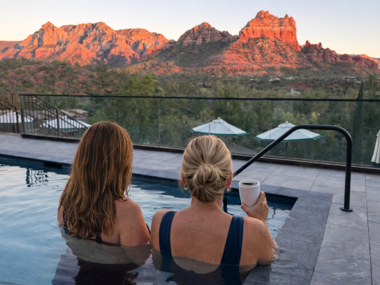 Duck Pond Sunset Females in the pool with a drink in hand.